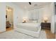 Comfortable bedroom features neutral decor, soft textures and a modern ensuite bathroom at 19 Isleworth Dr, Henderson, NV 89052