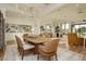 Elegant dining area with wood floors, designer chandelier, and views to the home's open spaces at 19 Isleworth Dr, Henderson, NV 89052