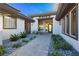 Inviting entryway with stone walkway and lush desert landscaping enhances curb appeal at 19 Isleworth Dr, Henderson, NV 89052
