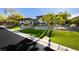 Beautifully landscaped front yard with lush green grass and mature palm trees at 19 Isleworth Dr, Henderson, NV 89052