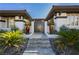 Inviting modern home entrance featuring a secure metal gate, landscaping, and a pathway to the front door at 19 Isleworth Dr, Henderson, NV 89052
