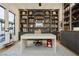 Stylish home office with custom built-in shelving and cabinets, a large desk, and natural light at 19 Isleworth Dr, Henderson, NV 89052