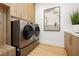 Modern laundry room with sleek appliances, ample storage, and stylish countertops at 19 Isleworth Dr, Henderson, NV 89052