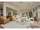 Open-concept living area with hardwood floors, elegant furnishings, and plenty of natural light at 19 Isleworth Dr, Henderson, NV 89052