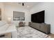 Cozy living room featuring a comfortable couch, TV, and neutral accents at 19 Isleworth Dr, Henderson, NV 89052