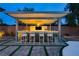Entertaining outdoor bar area with seating, modern lighting, and a built-in countertop at 19 Isleworth Dr, Henderson, NV 89052