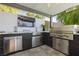 Outdoor grilling area with a stainless steel grill, sleek cabinetry, and countertop space for food preparation at 19 Isleworth Dr, Henderson, NV 89052