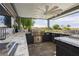 Outdoor kitchen with stainless steel grill, countertop space, and a ceiling fan for comfortable cooking and entertaining at 19 Isleworth Dr, Henderson, NV 89052