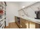 Well-organized pantry featuring custom shelving, wood-look cabinets, and marble countertops at 19 Isleworth Dr, Henderson, NV 89052
