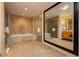 Elegant bathroom featuring full bathtub, glass shower, and expansive wall mirror at 2000 Fashion Show Dr # 3526, Las Vegas, NV 89109