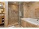 A designer bathroom featuring a large walk-in shower and bathtub with gorgeous fixtures and marble tiling at 2000 Fashion Show Dr # 3526, Las Vegas, NV 89109