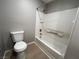 Bathroom features a white shower-tub combo and a standard toilet with tile flooring at 2105 William Holden Ct, Las Vegas, NV 89142