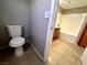 Bathroom features a standard toilet, shower-tub combo and tile flooring at 2105 William Holden Ct, Las Vegas, NV 89142