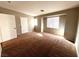 Primary bedroom offers neutral paint and carpet flooring with large windows at 2105 William Holden Ct, Las Vegas, NV 89142