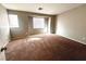 Bedroom with neutral paint, carpet floors, and windows at 2105 William Holden Ct, Las Vegas, NV 89142