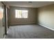 Spacious carpeted bedroom features a large window for natural light and a closet with sliding mirror doors at 228 Moose Ln, Las Vegas, NV 89145