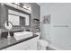 Modern bathroom featuring gray tile, a large mirror, and updated fixtures at 2615 W Gary Ave # 1028, Las Vegas, NV 89123