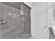 Bathroom with a large glass shower and gray tile at 2615 W Gary Ave # 1028, Las Vegas, NV 89123