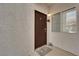 Welcoming entrance to condo unit features a secure door, ample natural light, and a decorative welcome mat at 2615 W Gary Ave # 1028, Las Vegas, NV 89123