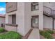 Close-up of a condo unit's entrance, highlighting a private patio area, lush landscaping, and convenient stair access at 2615 W Gary Ave # 1028, Las Vegas, NV 89123