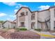 Exterior view of a condo building with private balconies, landscaped grounds, and convenient access to stairs and parking at 2615 W Gary Ave # 1028, Las Vegas, NV 89123