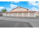 Row of garages featuring light-colored doors, part of an apartment or townhome complex, under a sunny sky at 2615 W Gary Ave # 1028, Las Vegas, NV 89123