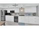 Well-lit kitchen with white cabinetry, stainless appliances, and patterned backsplash for modern appeal at 2615 W Gary Ave # 1028, Las Vegas, NV 89123