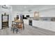 Bright kitchen with white cabinets, stainless steel appliances, and a dining area with seating at 2615 W Gary Ave # 1028, Las Vegas, NV 89123