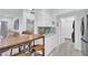 Inviting kitchen with breakfast bar, stylish white cabinets, and adjacent living area for seamless living at 2615 W Gary Ave # 1028, Las Vegas, NV 89123