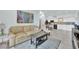 Inviting living room boasts a comfortable leather sofa, contemporary art, and open access to the modern kitchen at 2615 W Gary Ave # 1028, Las Vegas, NV 89123