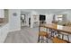Open concept living space with stylish decor, hardwood floors, and seamless flow into the kitchen area at 2615 W Gary Ave # 1028, Las Vegas, NV 89123