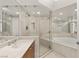 Bright bathroom featuring a glass-enclosed shower, soaking tub, and vanity at 2777 Paradise Rd # 1208, Las Vegas, NV 89109