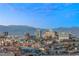 Expansive city skyline view showcasing iconic buildings and the surrounding mountains under a bright blue sky at 2777 Paradise Rd # 1208, Las Vegas, NV 89109
