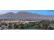 Scenic view of the city sprawling beneath majestic mountains, with lush green trees in the foreground at 2777 Paradise Rd # 1208, Las Vegas, NV 89109