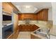 Well-appointed kitchen with wood cabinetry, granite countertops, and stainless steel appliances at 2777 Paradise Rd # 1208, Las Vegas, NV 89109