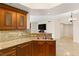 Elegant kitchen featuring stainless steel sink, granite counters, and wood cabinetry at 2777 Paradise Rd # 1208, Las Vegas, NV 89109
