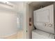 Convenient laundry closet with a stacked washer and dryer unit; neutral colors at 2777 Paradise Rd # 1208, Las Vegas, NV 89109
