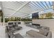 Luxurious outdoor living space with plush seating, a modern fireplace, and a built-in grill for entertaining at 2777 Paradise Rd # 1208, Las Vegas, NV 89109