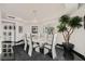Bright dining area with a modern chandelier, oval table, and sleek black floors at 2857 Paradise Rd # 2704, Las Vegas, NV 89109