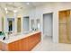 Spacious bathroom with double sinks, a soaking tub, and glass-enclosed shower, offering a modern and functional design at 2877 Paradise Rd # 104, Las Vegas, NV 89109