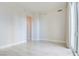 Bright and open bedroom area with tile floors, balcony access, and neutral wall color at 2877 Paradise Rd # 104, Las Vegas, NV 89109