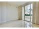 Bright, spacious bedroom with tile floors and sliding glass doors to the balcony at 2877 Paradise Rd # 104, Las Vegas, NV 89109