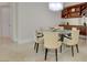 Dining area featuring a glass table, cabinet, and modern chandelier with tile floors at 2877 Paradise Rd # 104, Las Vegas, NV 89109