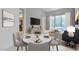 Modern dining area with table setting and open floor plan leading to living spaces at 2877 Paradise Rd # 104, Las Vegas, NV 89109