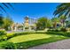 Grand entrance with ornate gate, lush lawn, and manicured hedges leading to a luxurious resort at 2877 Paradise Rd # 104, Las Vegas, NV 89109