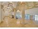 Elegant entry hall with marble floors, stately pillars, and intricate ceiling details beneath a sparkling chandelier at 2877 Paradise Rd # 104, Las Vegas, NV 89109