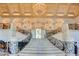 Breathtaking grand foyer featuring a stunning chandelier, marble staircase, and wrought iron railings at 2877 Paradise Rd # 104, Las Vegas, NV 89109