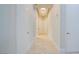 Hallway with sleek tile flooring, recessed lighting, and clean, white doors at 2877 Paradise Rd # 104, Las Vegas, NV 89109