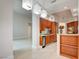 Modern kitchen with stainless steel appliances, wood cabinets, and stylish lighting at 2877 Paradise Rd # 104, Las Vegas, NV 89109