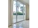 Bright room with patio door to balcony featuring palm trees and well-manicured landscaping at 2877 Paradise Rd # 104, Las Vegas, NV 89109